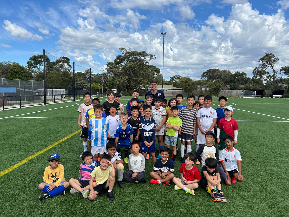 Pateka players dribbling through a drill on the school oval