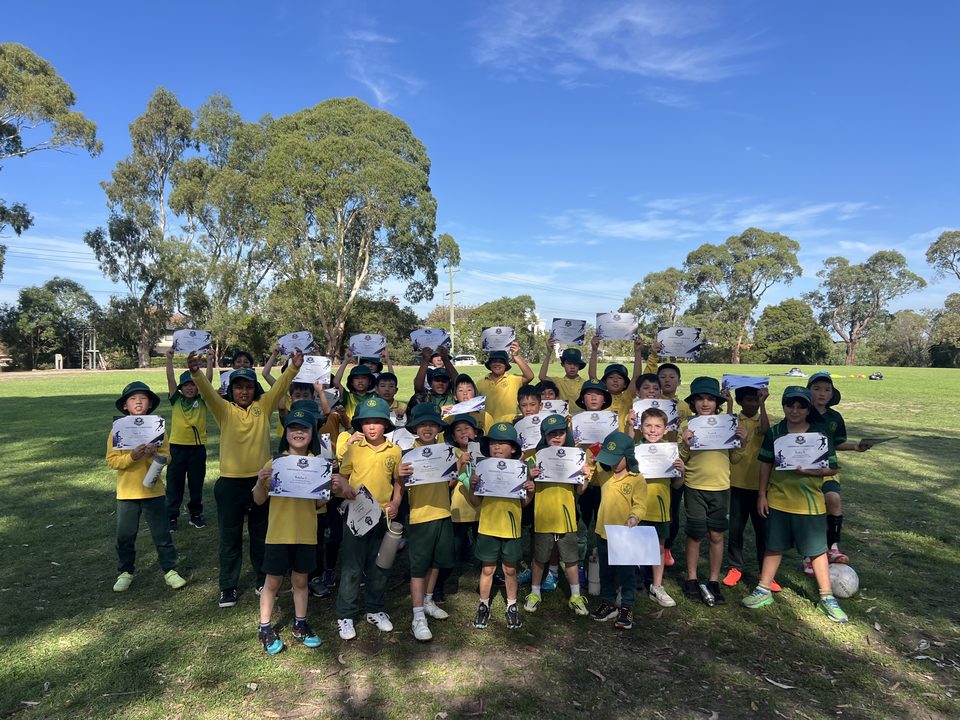 End-of-term certificates on the oval at a partner primary school